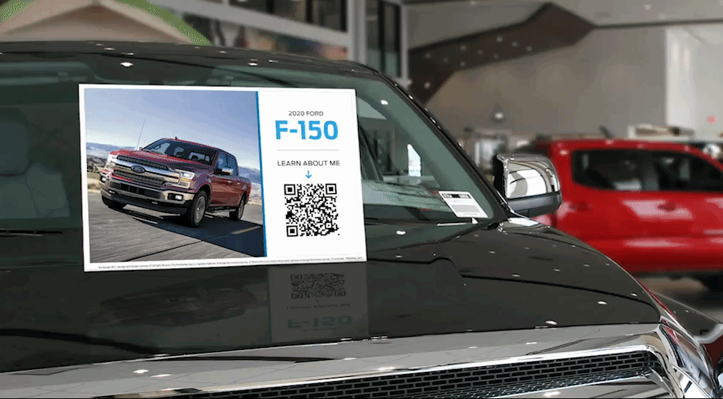 QR Code being scanned in a car dealership showroom